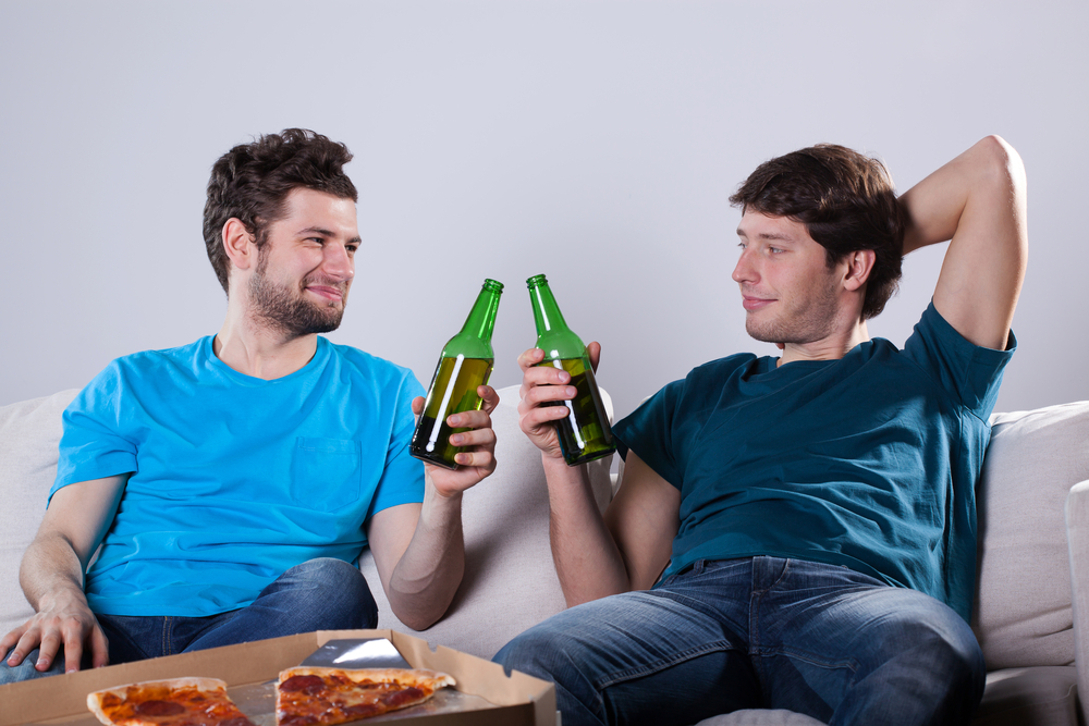 Men friends drinking beer and eating pizza